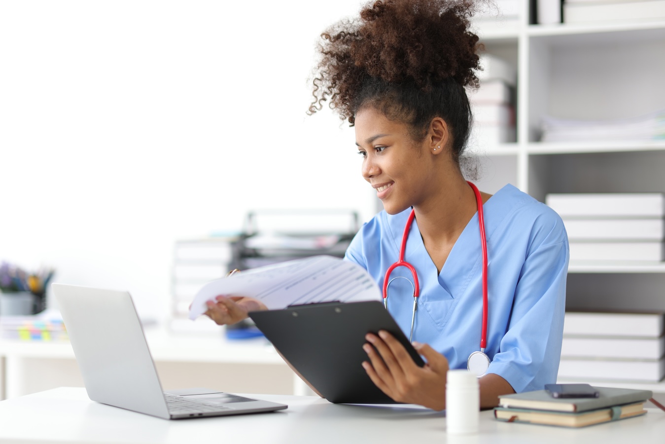 Smiling healthcare professional in office doing paperwork