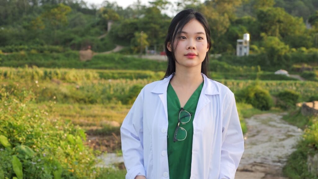 Female travel healthcare worker outside in beautiful landscape.