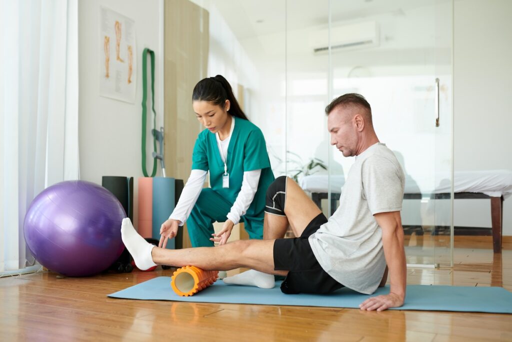 Travel physical therapist working with a patient to increase mobility.