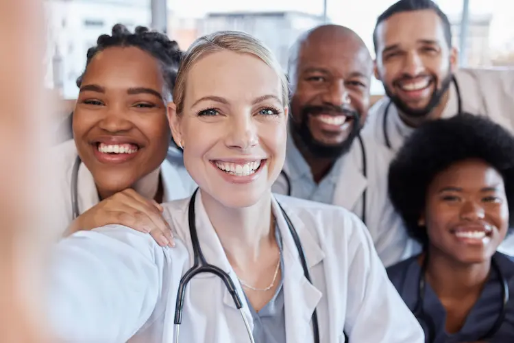 Happy group of clinicians taking a selfie together.